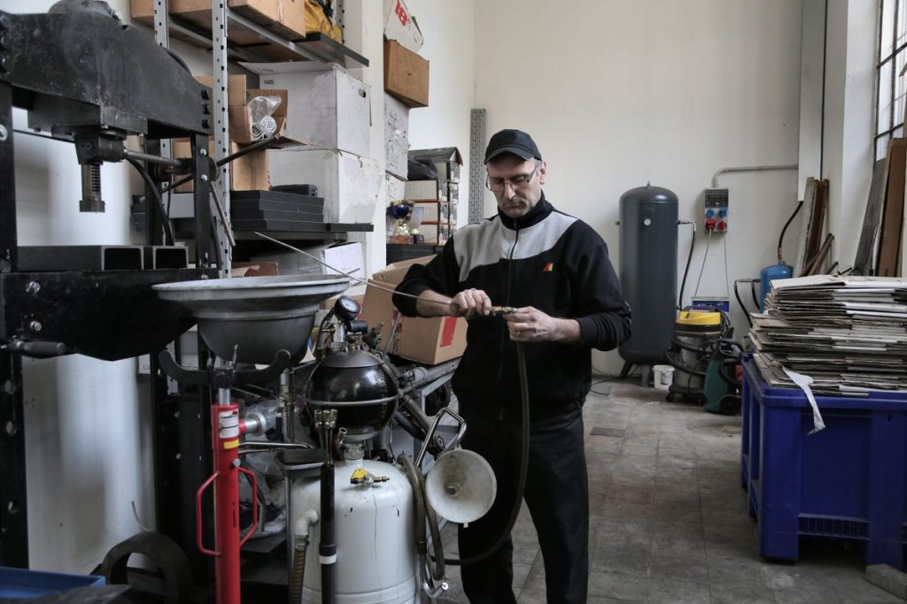 Mechanic repairing compressor hose