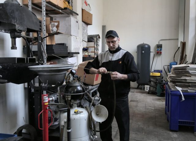 Mechanic repairing compressor hose