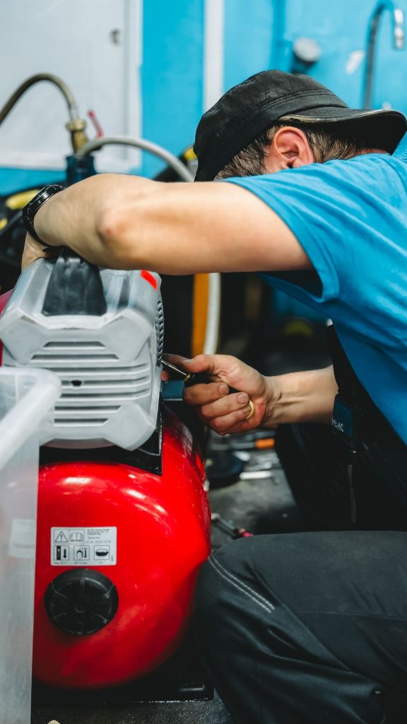 Technician repairing industrial air compressors